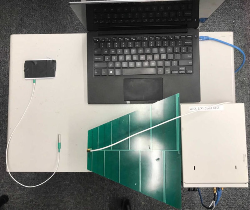 The setup used to test the effect of radio interference on temperature sensors. Clockwise from upper left: a real-time temperature logger, laptop, radio interference generator, antenna and temperature probe.