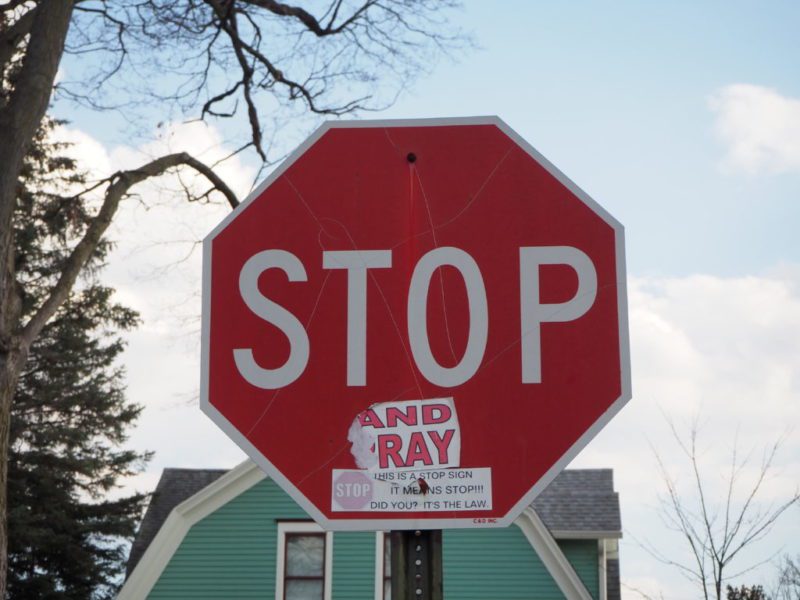 Stickers on this stop sign might throw off an autonomous vehicle that isn’t ready for them. Alternatively, a criminal who had identified a weakness in an AV vision system could add stickers to signs to deliberately cause accidents. The new immune-inspired algorithm offers a way to defend against this type of attack. (Courtesy of: Michigan Engineering)